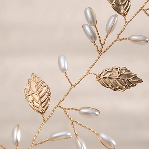 Elegant bridal hair vine with handmade pearls and gold metal leaves for wedding hairstyles