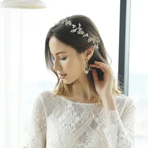 Détail d'un accessoire de cheveux de mariage argenté avec perles et cristaux sur mariée