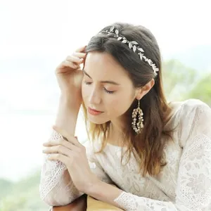 Detail of silver bridal leaf headband with crystals and matching teardrop pearl earrings