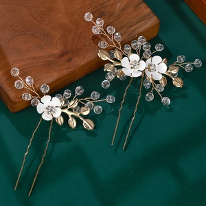 Elegant gold bridal hair pins with white flowers and crystals for weddings, set of two