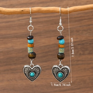 Detail view of Bohemian dangle earrings with turquoise beads and heart pendant