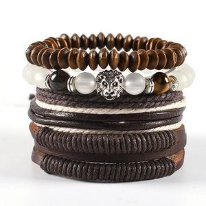 Detail of vintage multilayer leather bracelets with lion head charm and tiger eye beads