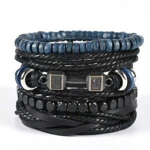 Detail of multi-layer leather bracelets featuring dumbbell charm with motivational engraving
