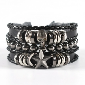 Macro shot of multi-layer punk leather bracelet with skull and star metal charms