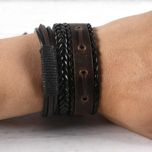 Close-up of multilayer leather bracelet with braided strands and metallic eyelets on wrist