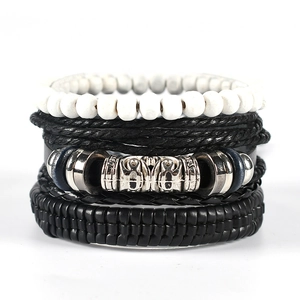 Detailed macro view of multi-layered punk leather bracelet with vintage beads and metal charm