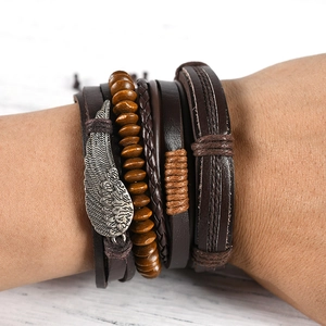Men's multilayer vintage leather bracelet with wing charm and wooden beads on wrist
