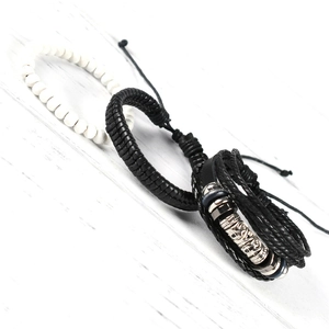 Detail of vintage men's bracelet set with white beads, braided leather, and silver charms