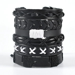 Detail view of woven owl wing leather bracelets with multi-layered punk style design