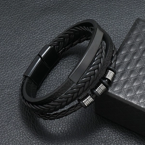 Macro detail of multi-strand black braided leather bracelet with magnetic metal clasp