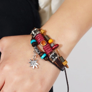 Vintage multilayer leather bracelet with sun and evil eye pendant in bohemian style