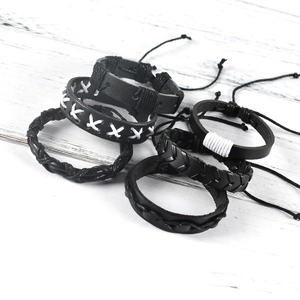 Detail of 6-piece men's punk leather bracelet set with braided patterns and owl wing elements