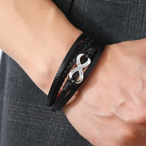 Men's black multilayer leather bracelet with silver infinity symbol on suit background