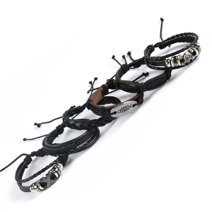 Macro view of men's punk leather bracelet set featuring skull and fish alloy charms