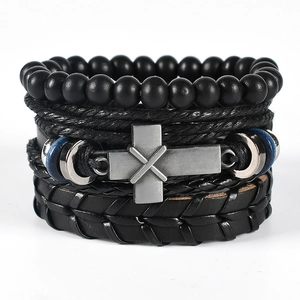 Detail view of multi-layer leather bracelets with black onyx beads and metal cross charm