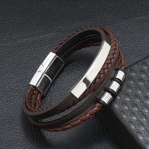 Detail of multilayer brown braided leather bracelet with silver magnetic metal clasp