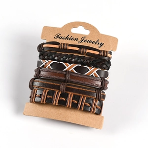 Detail view of multi-layer men's braided leather bracelets set with owl wing punk style