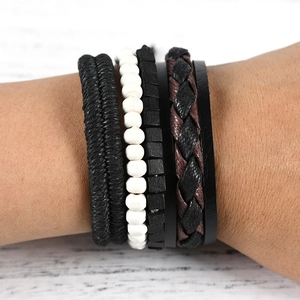 Detail of vintage layered men's bracelet set with black woven leather and wooden beads