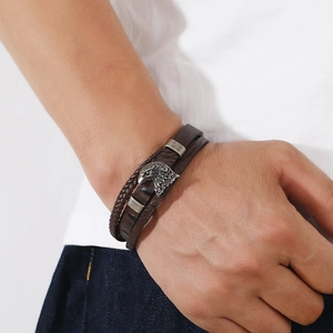 Close-up of braided leather bracelet featuring vintage silver eagle alloy clasp on wrist
