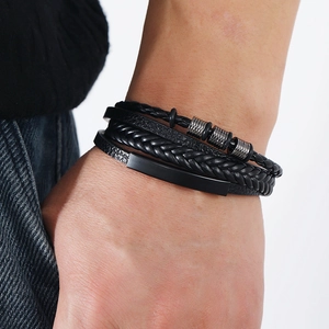 Close-up of multilayered black braided leather bracelet worn on a male wrist