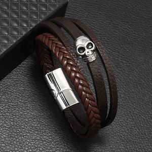Men's dark brown multilayer leather skull bracelet with magnetic clasp on black texture