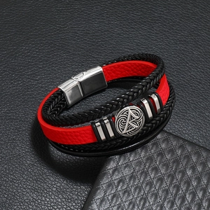 Macro shot of multi-layer braided leather bracelet with vintage compass metal badge