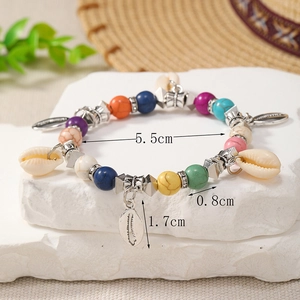 Detail view of colorful bohemian shell charm bracelet with 0.8cm beads and 5.5cm diameter