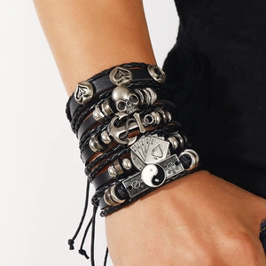 Detail of adjustable leather skull bracelet with anchor and poker cards charms