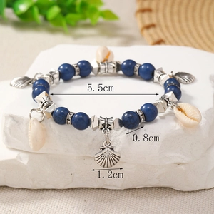 Detail of bohemian shell bracelet with size dimensions 5.5cm diameter and 0.8cm beads