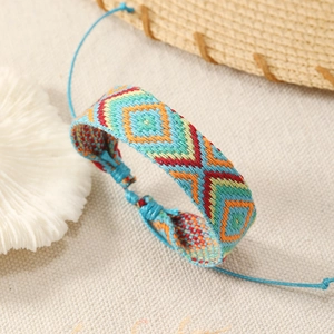Handmade Bohemian woven bracelet featuring colorful geometric patterns and adjustable blue cord