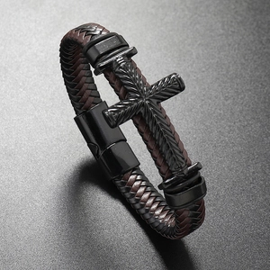 Detail of woven leather bracelet with black metal cross and magnetic matte clasp