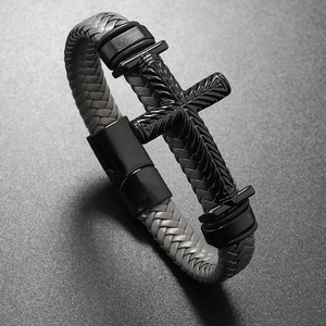 Close-up of men's gray woven leather bracelet with a black engraved metal cross