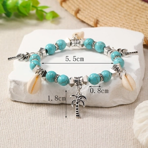 Detail showing tropical turquoise beads with palm tree, moon, and seashell pendants