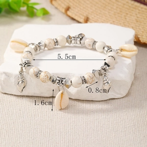Detail shot of bohemian beaded bracelet with shell charms and 8mm stone beads