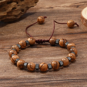 Détail du bracelet surfeur en perles de bois avec hématite et cordon tressé ajustable
