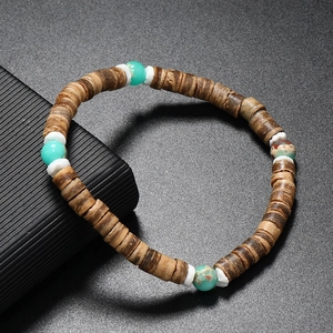 Détail d'un bracelet en perles avec pierres turquoises, noix de coco et intercalaires blancs