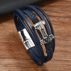 Detail of blue braided leather bracelet with silver Thor's hammer and magnetic clasp