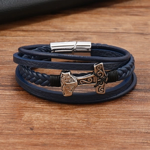 Detailed macro view of dark blue braided leather bracelet featuring Mjolnir hammer charm