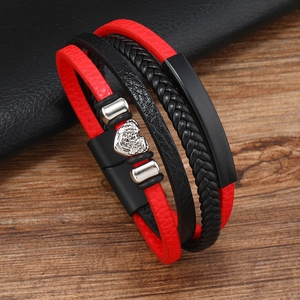 Multilayer leather bracelet with silver heart pendant and magnetic clasp on wood