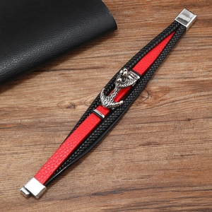 Detail of multi-layer braided leather bracelet with silver lion head and metal clasp