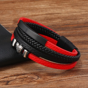 Detail of multi-layer braided leather bracelet with red-black cords and magnetic clasp