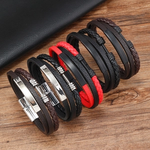 Detail of multi-layer braided leather bracelets for men with polished metal accents