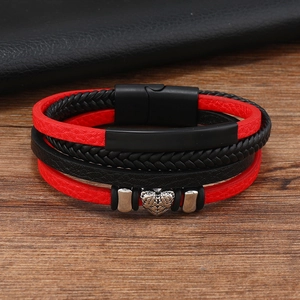 Detail view of multi-layer leather braided bracelet with magnetic clasp and heart charm