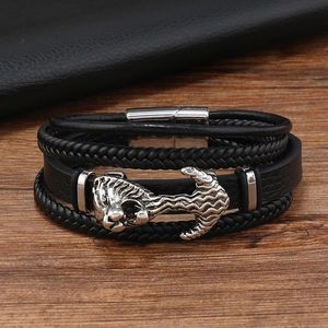 Close-up of multilayer leather bracelet featuring a silver lion head and magnetic clasp