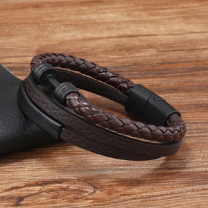Detail of dark brown multilayer braided leather bracelet with black magnetic clasp