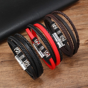 Detail of multi-layer braided leather bracelets with textured alloy magnetic clasps