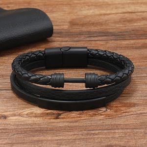 Men's multi-layer braided leather bracelet with black matte metal bar on wood background