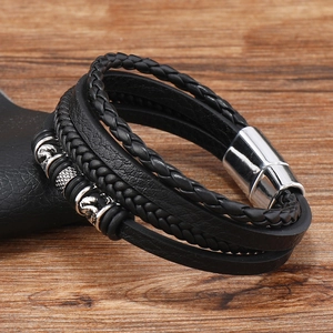 Detailed macro view of multilayered braided leather bracelet with silver magnetic clasp