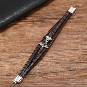 Detail of Thor's Hammer Mjölnir pendant on braided leather Viking bracelet with steel clasp