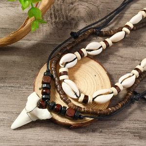 Detailed view of bohemian layered necklace with shark tooth and coconut shell beads